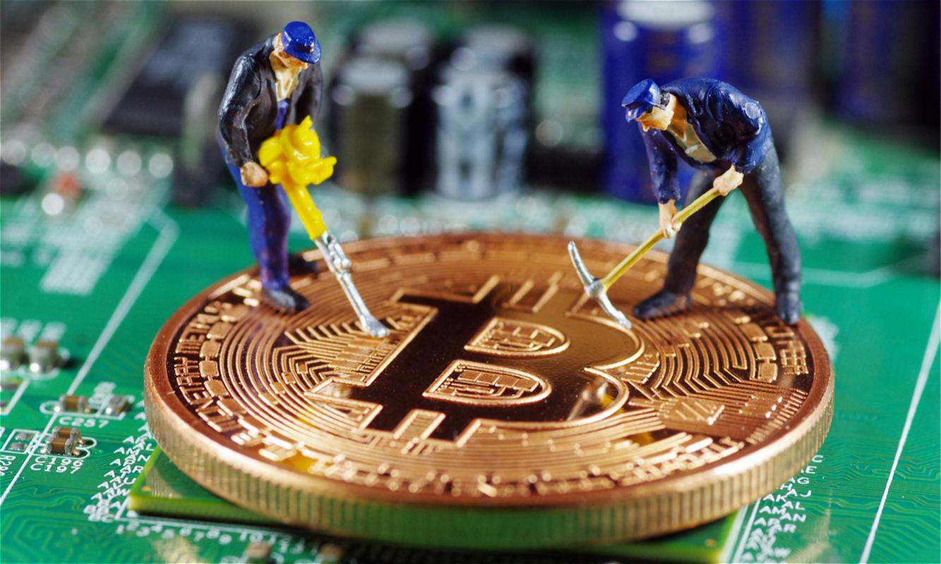 A miner examining the hashboard.